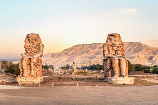 The Colossi of Memnon – two giant statues of Pharaoh Amenhotep III in Luxor West Bank, guarding ancient Thebes, part of top historical tour from Marsa Alam, Egypt
